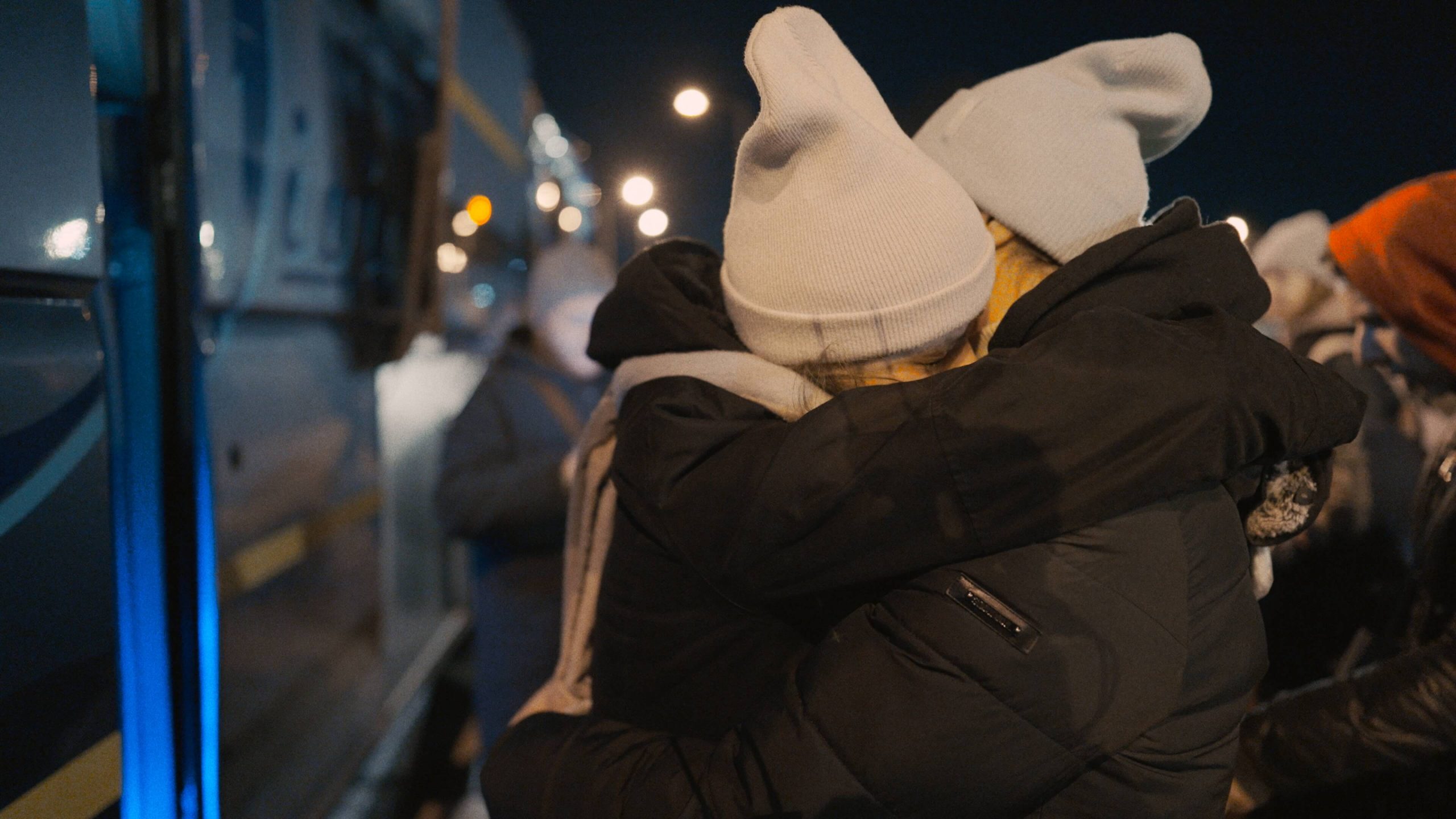 Two people embracing at night